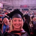 Lifelong learner Denise Johnson in cap and gown at a gown during her graduation ceremony at the University of Florida.