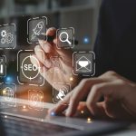 A man's hands working on a laptop overlaid with digital marketing-related icons