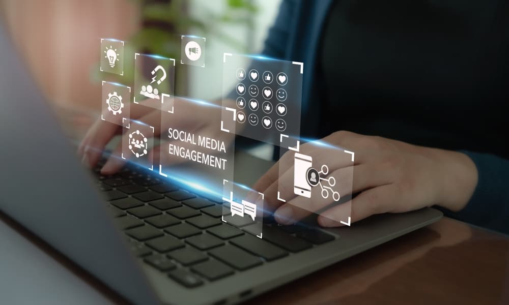 A conceptual image of a woman's hands working on a laptop overlaid with social media-related icons