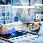 A conceptual image of a businessman working on his laptop and tablet, superimposed with data dashboard icons.