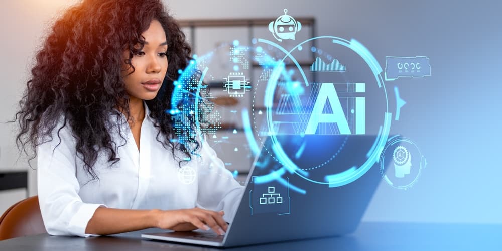 A young professional African American woman works on her laptop with AI and technology-releated icons superimposed on the image.